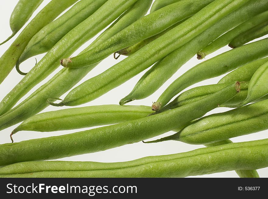 Many green beans on white background - viele gruene Bohnen auf weissem Hintergrund. Many green beans on white background - viele gruene Bohnen auf weissem Hintergrund