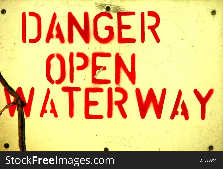Sign warning of open waterway. Sign warning of open waterway