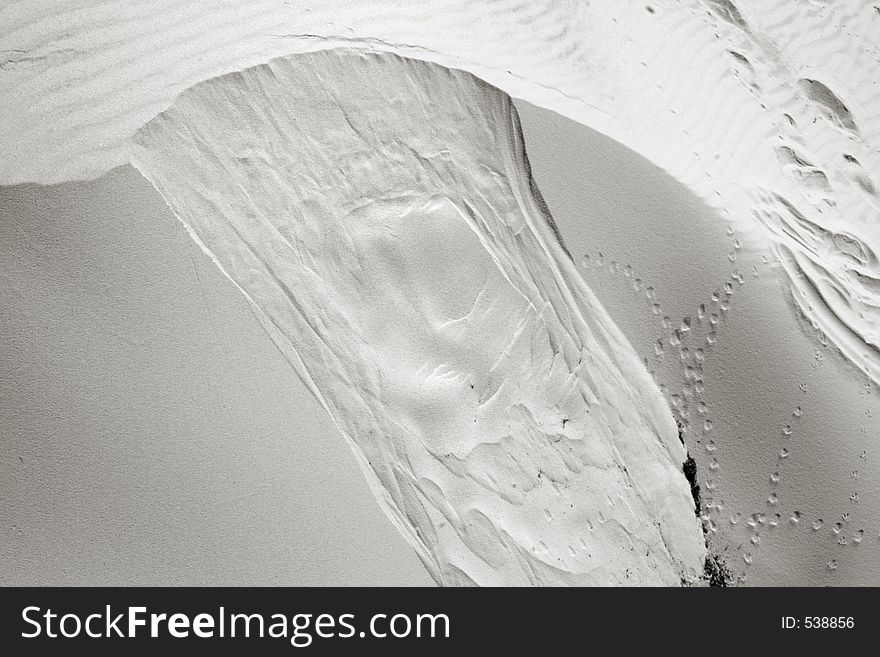 White sand dune with bird prints