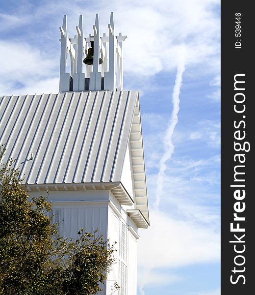 White church belfry against blue sky with clouds. White church belfry against blue sky with clouds