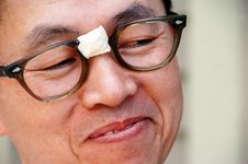 Smiling Asian Nerd In Glasses Royalty Free Stock Photos