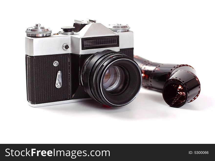 The old analog camera with an objective and a film