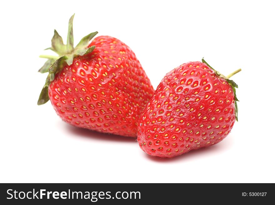 Two berry of a strawberry with foliage