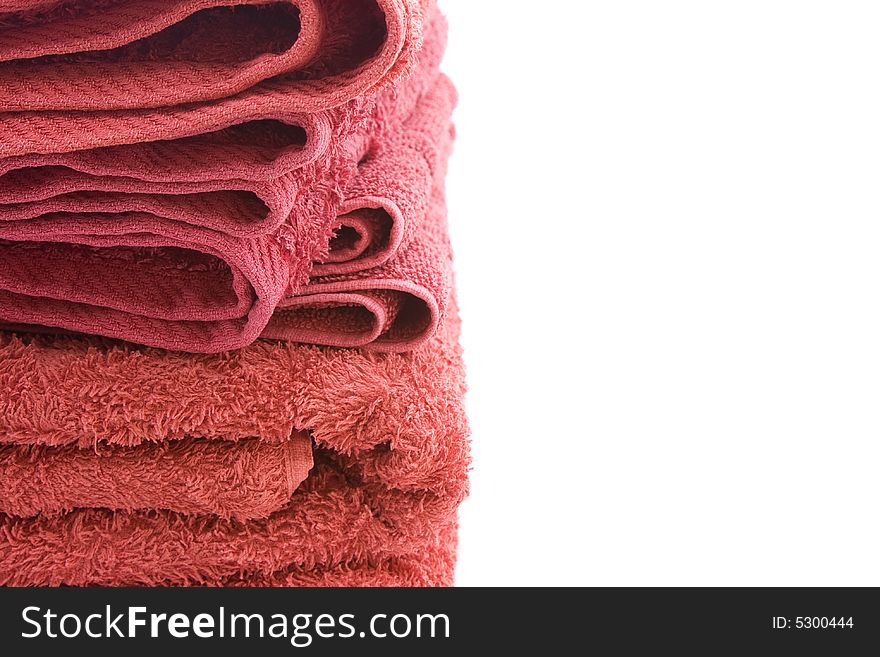 A stack of red bath towels against a white background