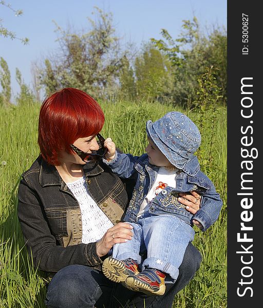 The little girl and her mum on a grass