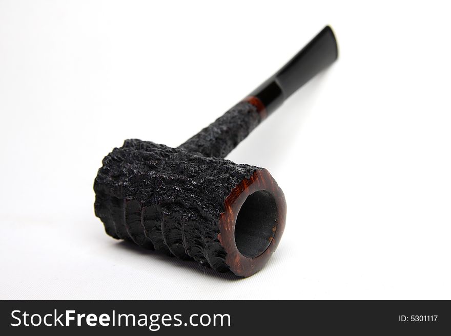 An black tobacco pipe isolated on white background.