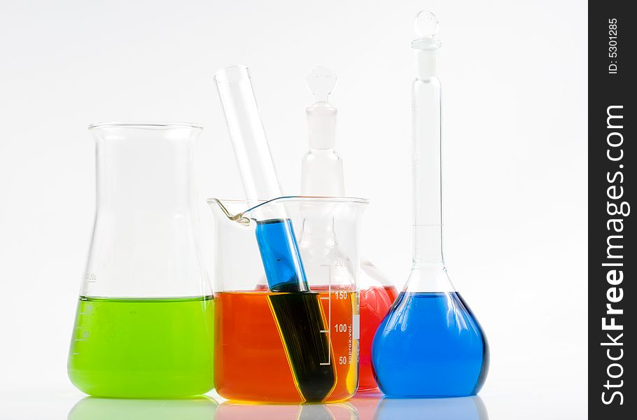 Various colorful flasks over white background