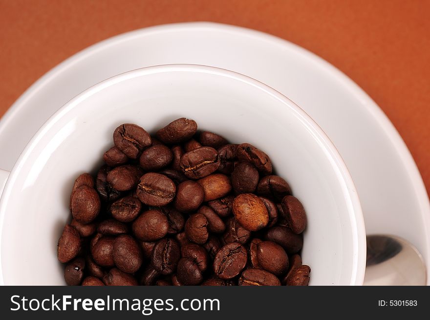 Macro studio shot of a cup of coffee beans.
