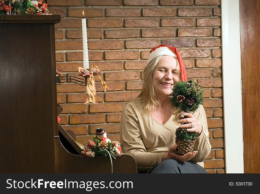 A Woman with Christmas decoration by a piano