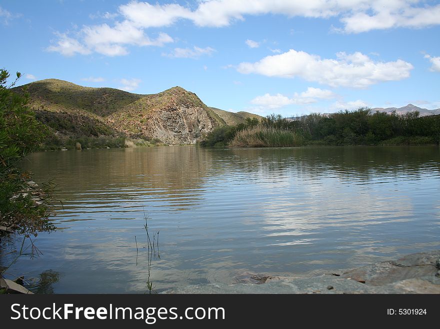 View of the river from the rocky bank. View of the river from the rocky bank