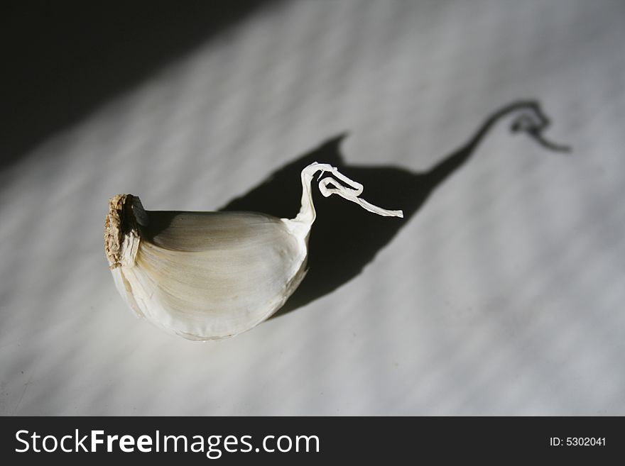 Garlic clove with shade on a table