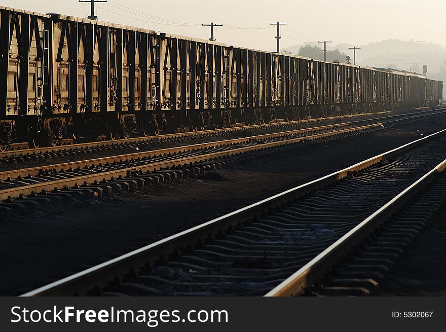 Freight cars ready to depart in a railway station in dawn.