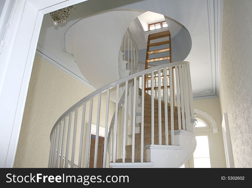 A circular staircase in a old mansion. A circular staircase in a old mansion