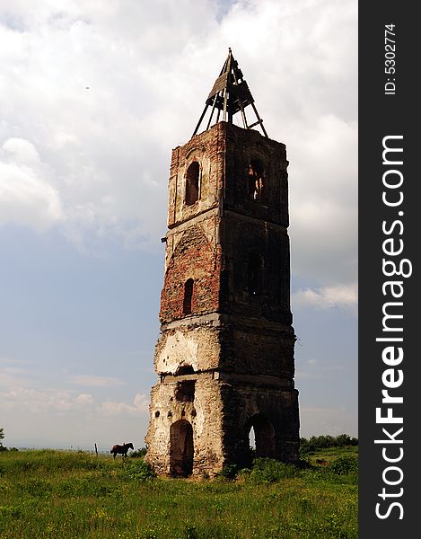 An old tower in the middle of a field