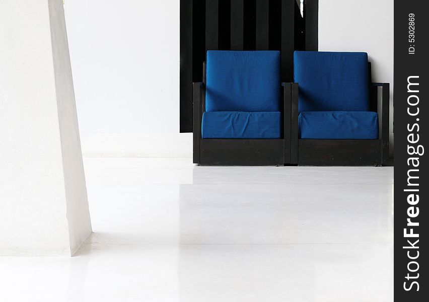 Two blue chairs in a modern interior.