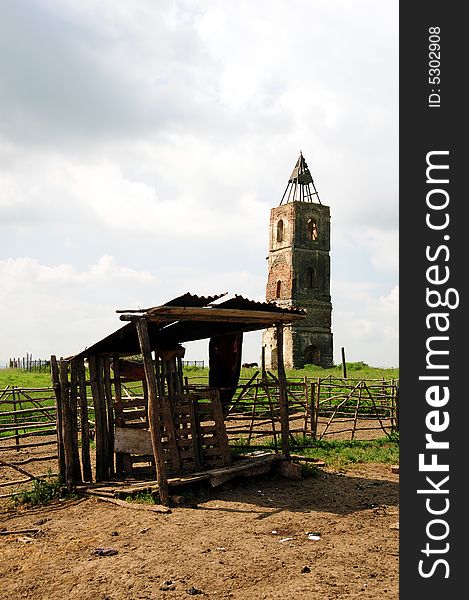 An old tower in the middle of a field