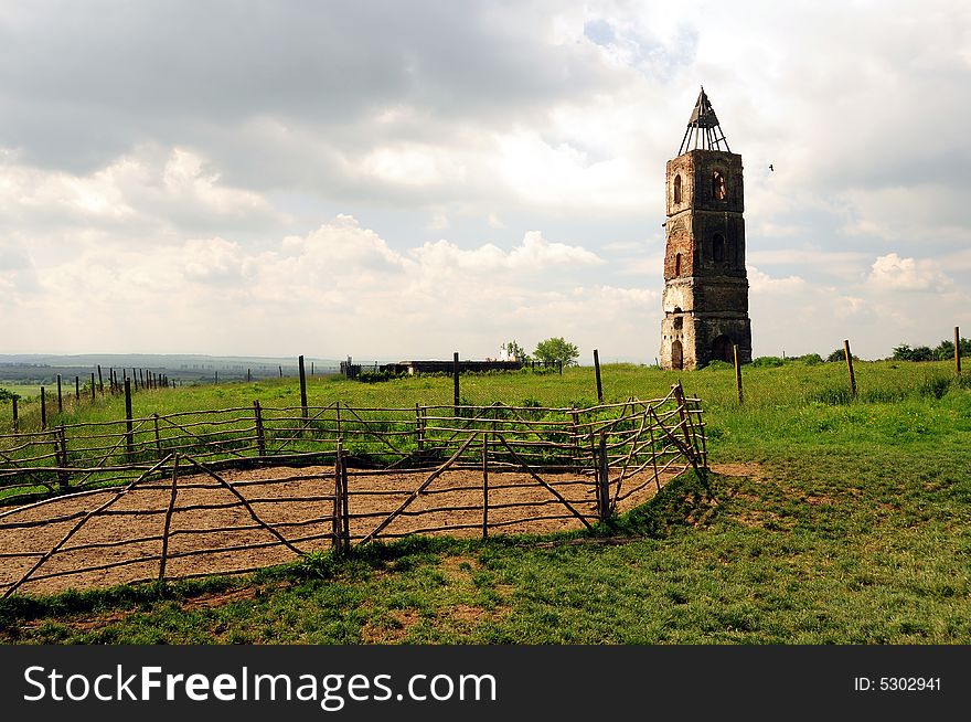An old tower in the middle of a field