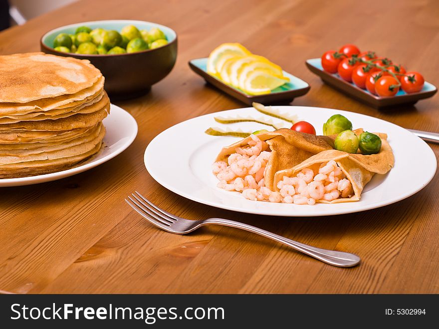Table served with pancakes, shrimps, Brussels sprouts. Table served with pancakes, shrimps, Brussels sprouts