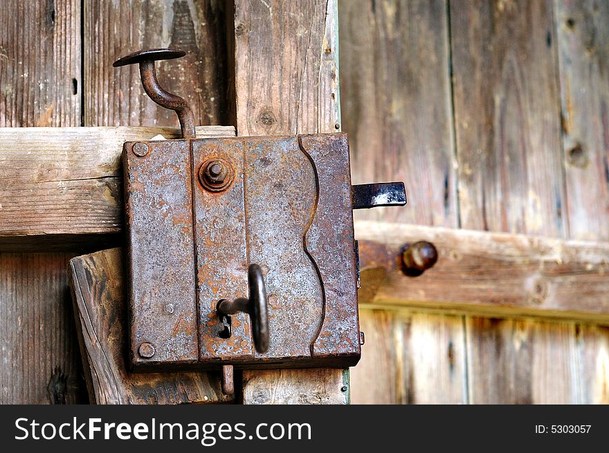 Old door lock at a wooden door