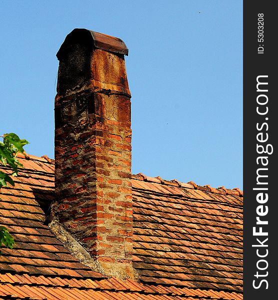 A view with tiles on the roof over blue sky. A view with tiles on the roof over blue sky