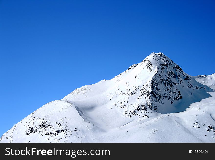 Snowy Alps in Switzerland under blue sky. Snowy Alps in Switzerland under blue sky