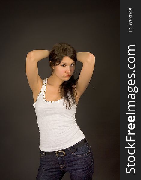 Fashion girl in jeans and top isolated on black. Fashion girl in jeans and top isolated on black