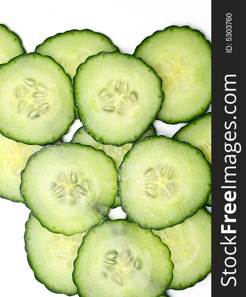 Cucumber slices from above isolated on white background