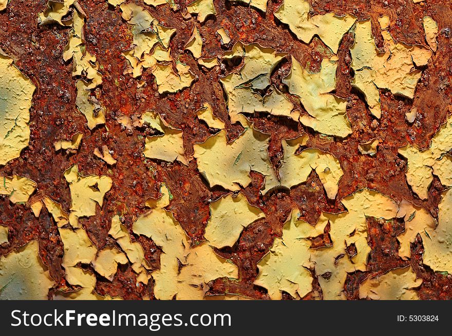 Paint peeling from a rusted metal object. Paint peeling from a rusted metal object