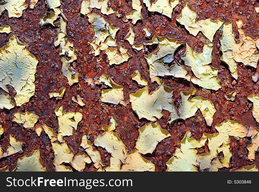 Paint peeling from a rusted metal object. Paint peeling from a rusted metal object