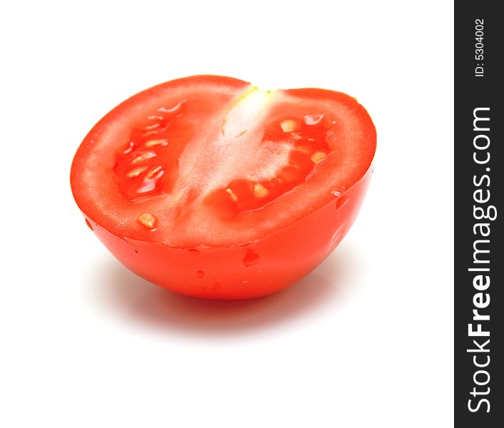 Segment of tomato. Isolation on white. Shallow DOF.