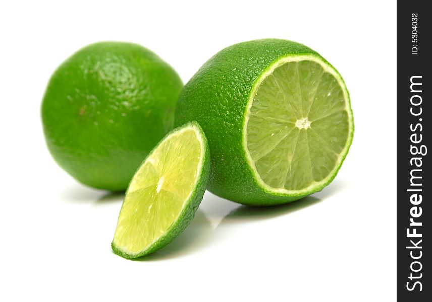 The tropical fruit known as lime, cut across. The image is isolated on white. Shallow DOF. Close-up. The tropical fruit known as lime, cut across. The image is isolated on white. Shallow DOF. Close-up.