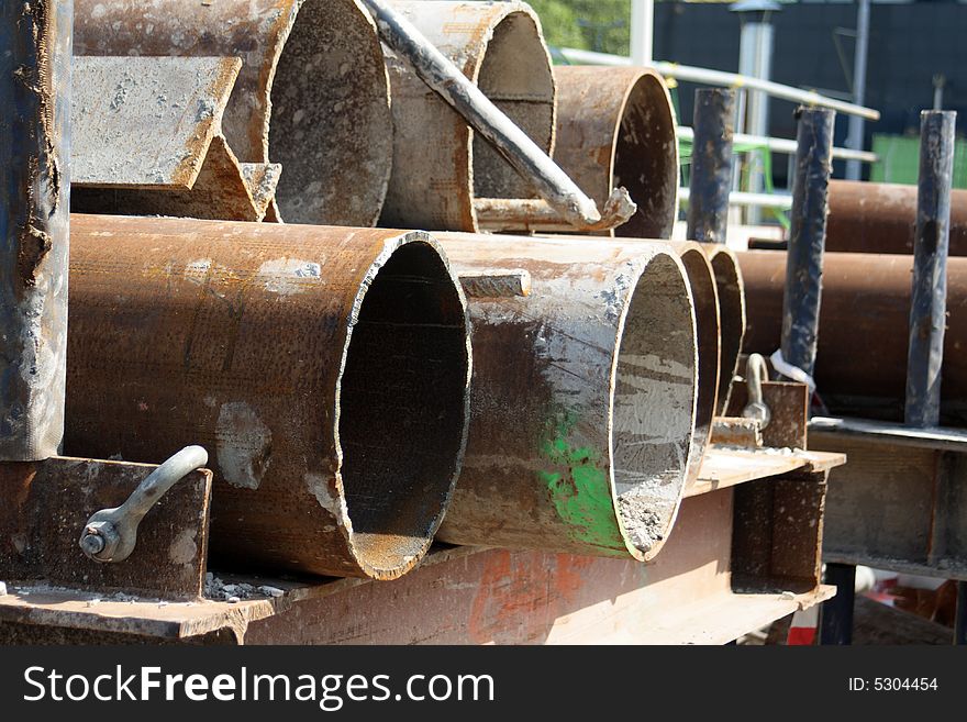 Rusty pipes on a construction site just waiting