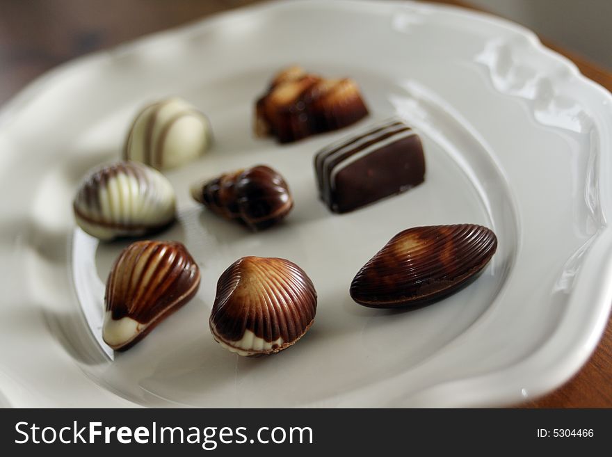 Chocolate pieces in various forms and sizes on a plate