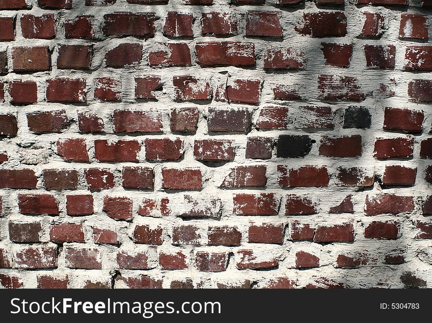 A wall of very weathered and aged bricks. A wall of very weathered and aged bricks.