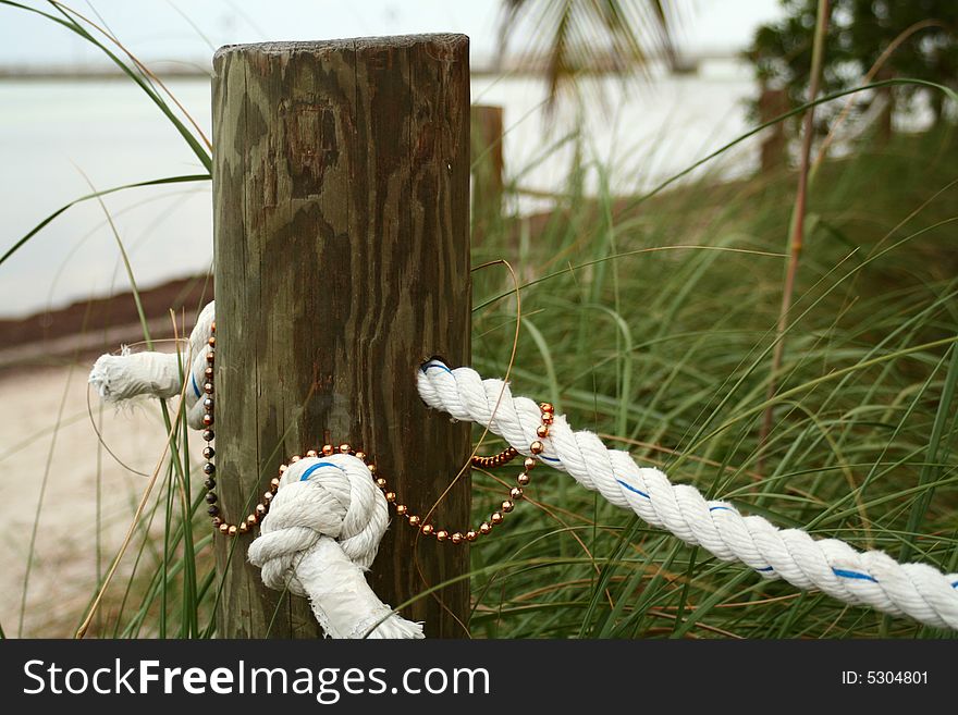 A wooden pole with festival beads left on it. A wooden pole with festival beads left on it.