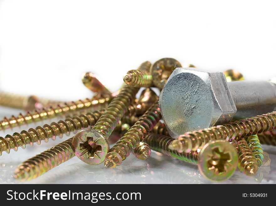 Bronze and nickel screws over white
