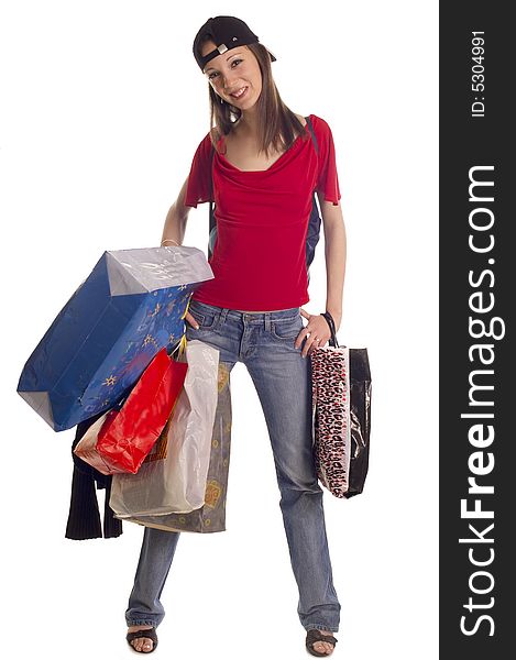 Young brunette girl holding bags and gifts after shopping