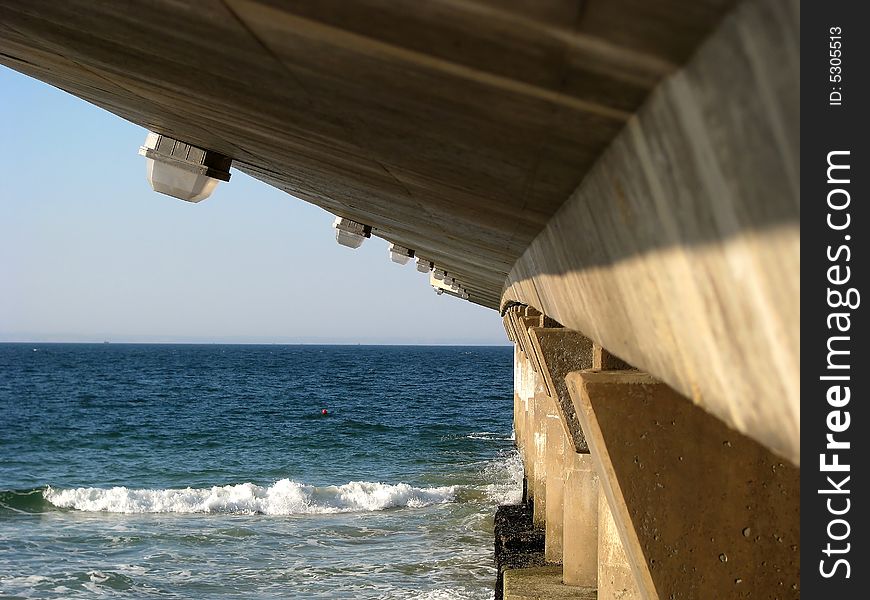 A concrete pier at the beach showing the architectural design. A concrete pier at the beach showing the architectural design