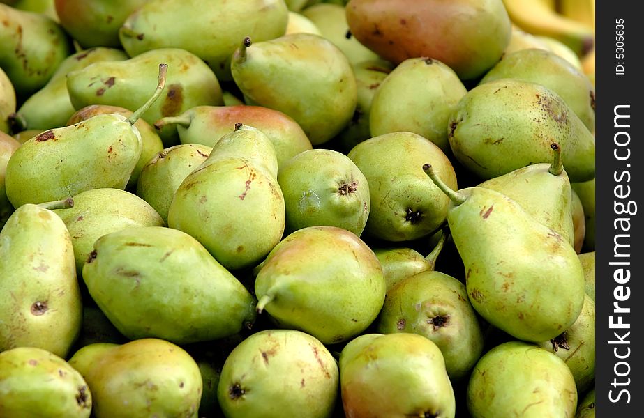 Pile of fresh green pears at for display at market