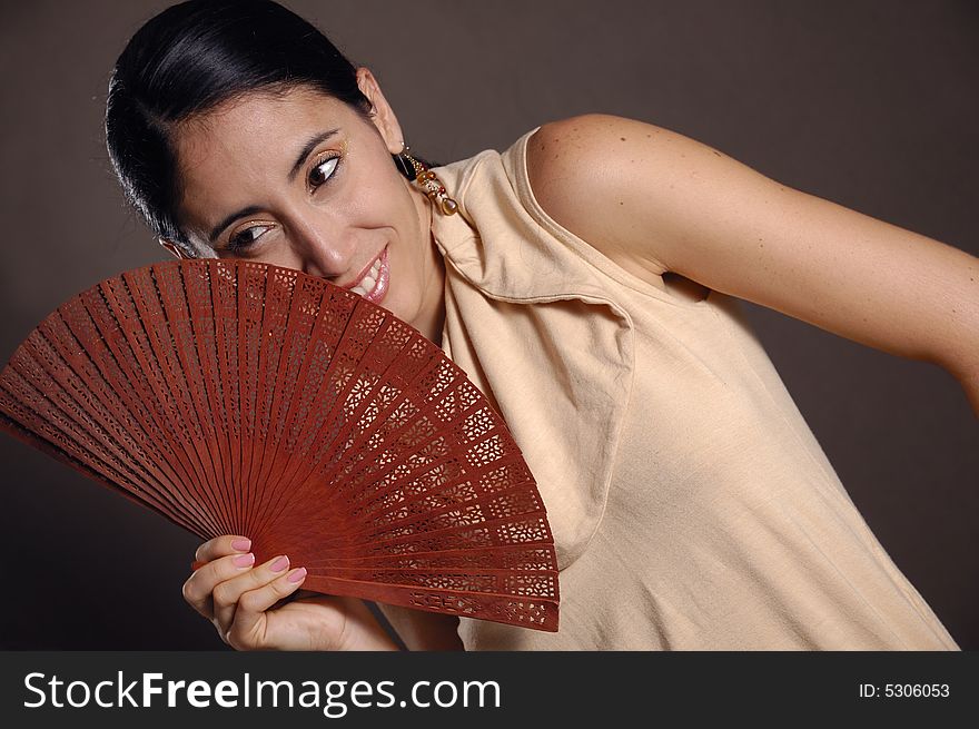 Portrait of hispanic young model holding traditional fan. Portrait of hispanic young model holding traditional fan