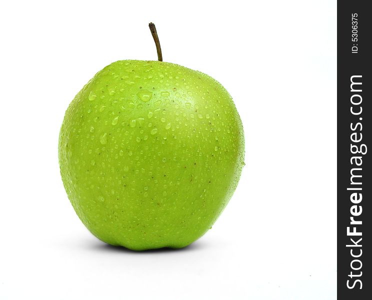 A fresh green apple with water drops