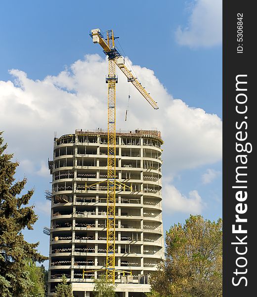 Reinforced concrete building under construction and tower crane