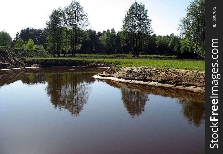 The new pond in the farm land. The new pond in the farm land