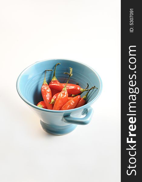 Bowl with a bunch of red hot chili peppers - isolated. Bowl with a bunch of red hot chili peppers - isolated