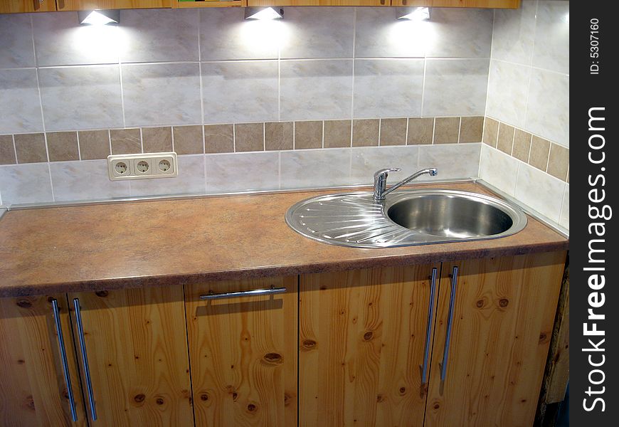 Stainless steel sink in the modern kitchen interior