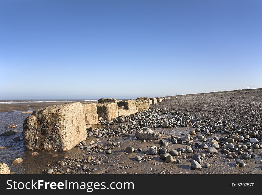 World War II tank block defences in 2008 on beach in East Yorkshire, England