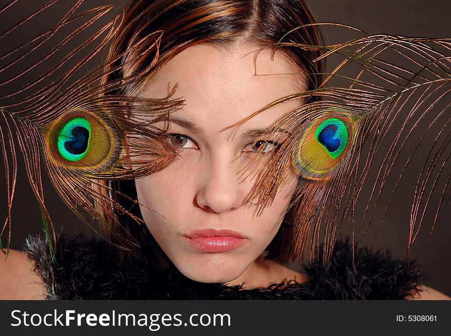 Portrait of fashion woman holding peacock feathers. Portrait of fashion woman holding peacock feathers