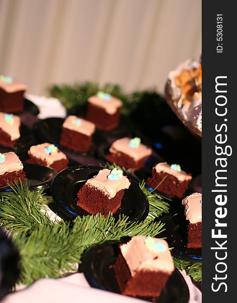 Close up of multiple pieces of chocolate cake on tiny plates