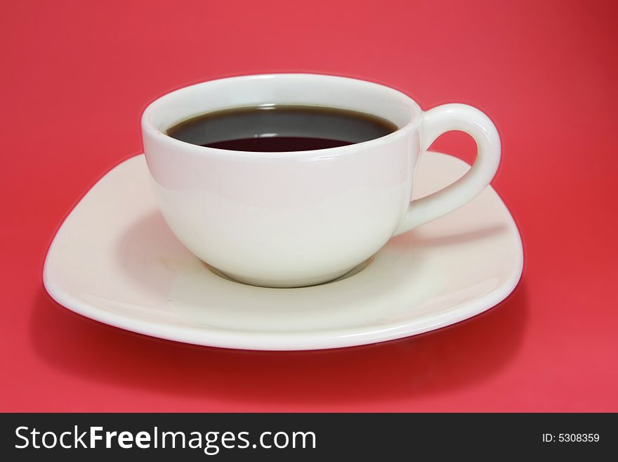 Coffee cup on red background