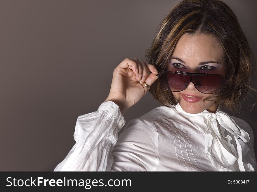 Portrait of fashion female wearing sunglasses with seductive smile. Portrait of fashion female wearing sunglasses with seductive smile